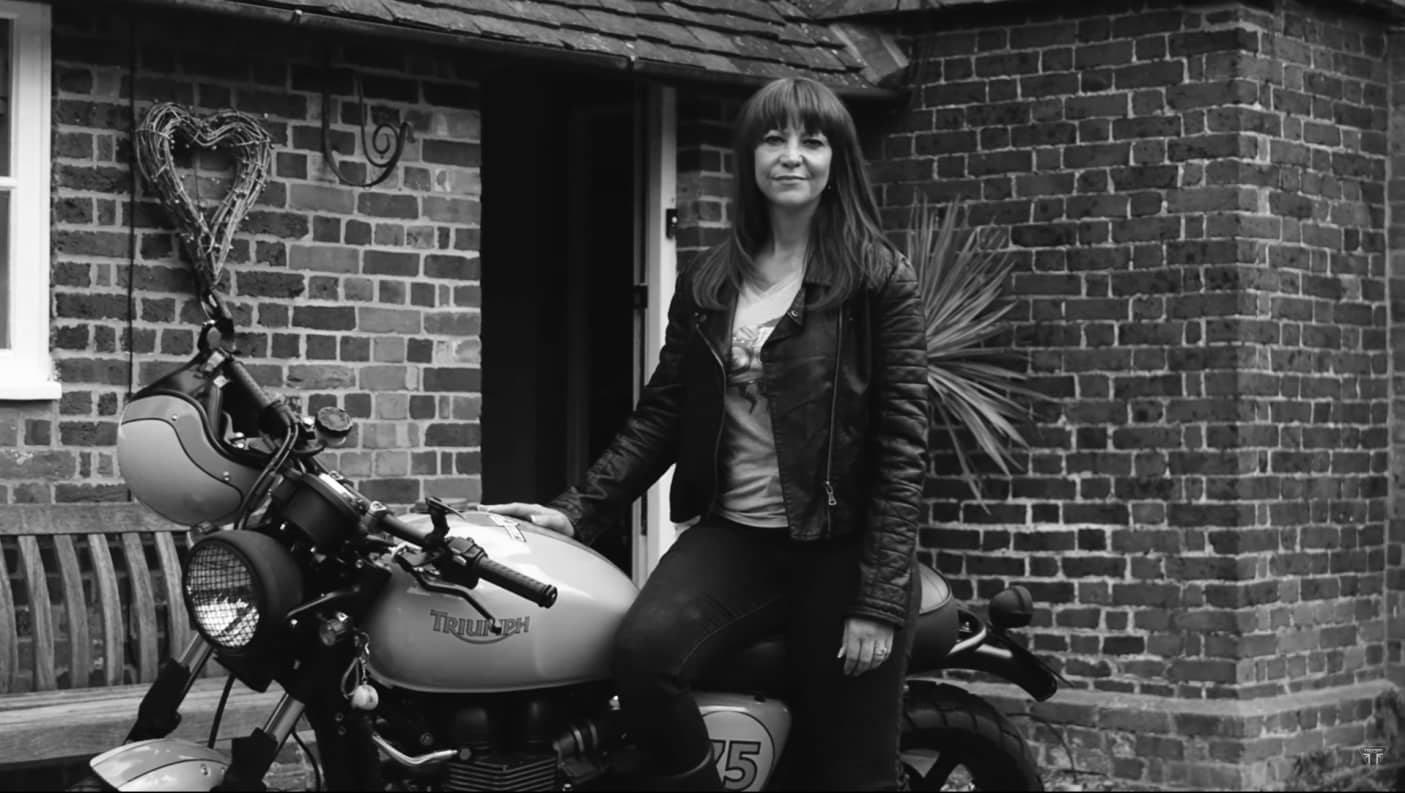 Black & white shot of Ina Lombard on her Triumph motorcycle ready for The Distinguished Gentleman's Ride